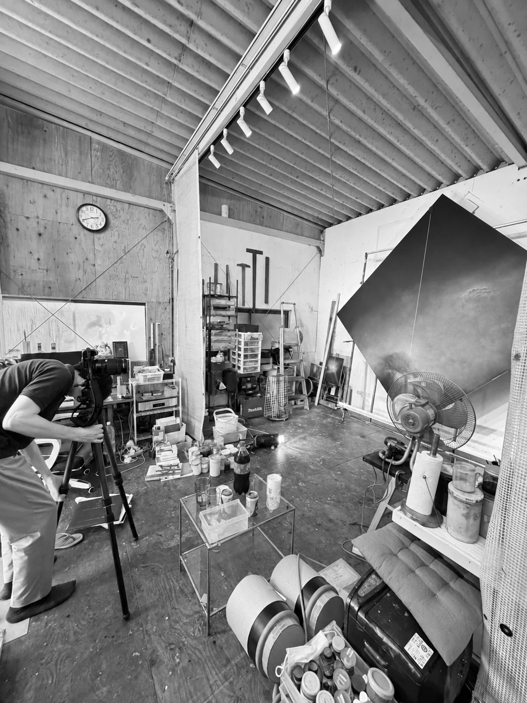 Rinpei Aoki working behind a camera to photograph an artwork in the studio.